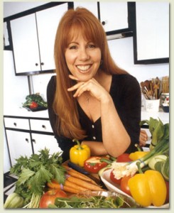 Portrait of Christina Pirello in her kitchen surrounded by fresh produce