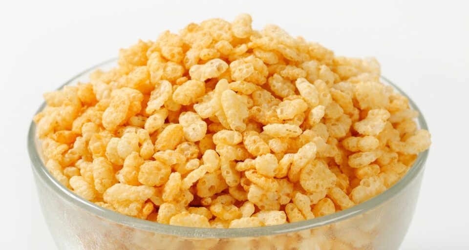 A glass bowl holds Rice Krispies cereal.