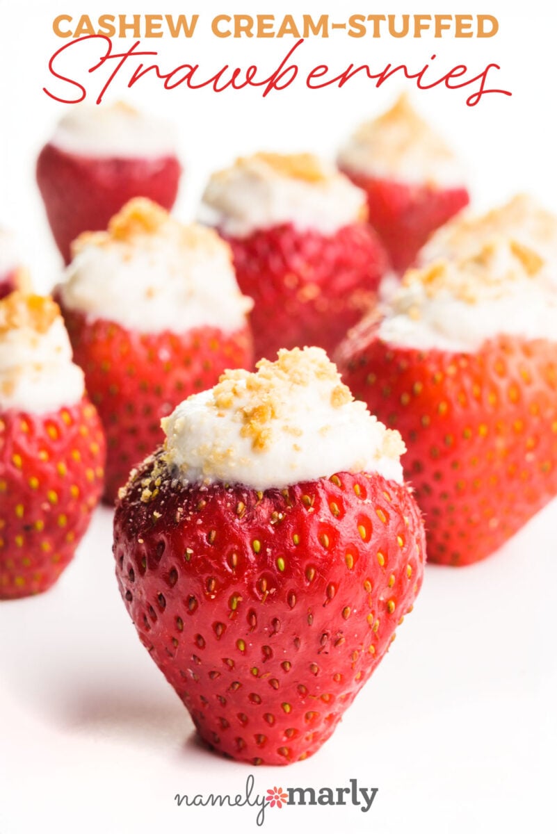 Cashew cream-stuffed strawberries topped with crumbly garnish, arranged against a white background.