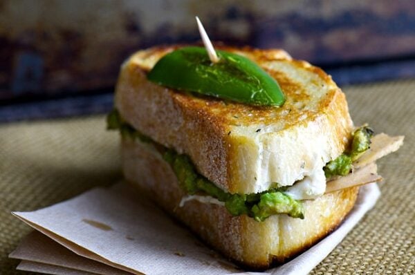A delicious vegan sandwich with sliced jalapeños and vegan cheese