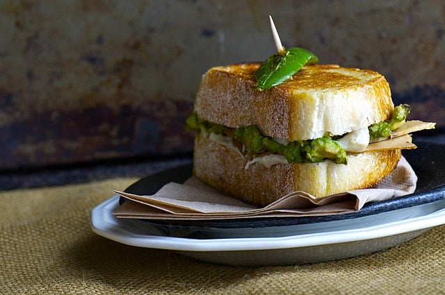Layers of faux turkey are adorned with other flavors to make a delicious vegan sandwich