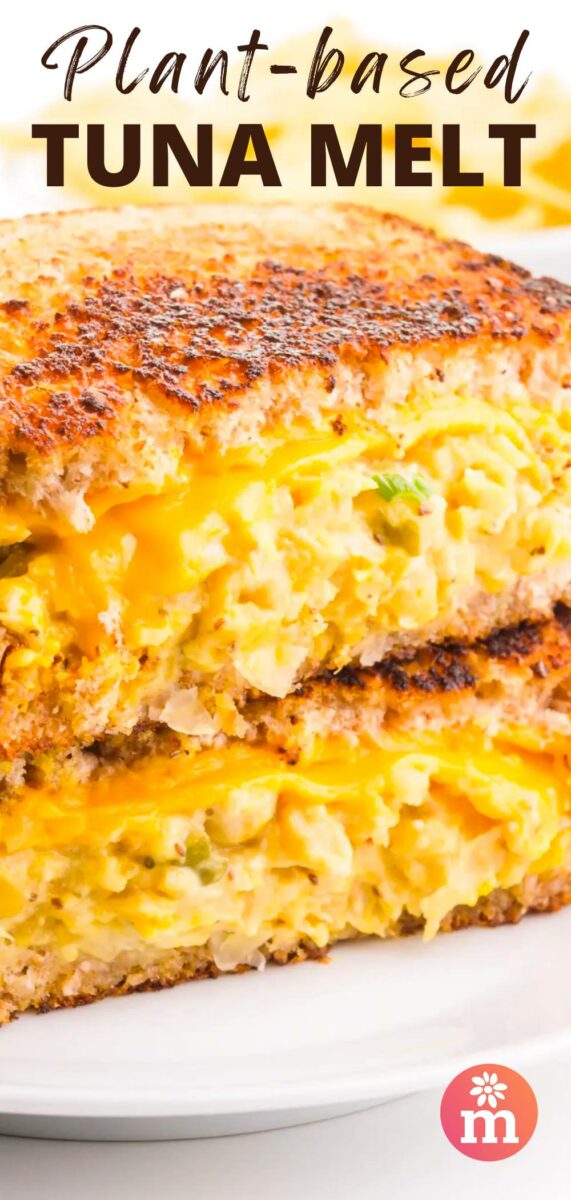Two halves of a chickpea tuna melt sandwich sit on top of each other. The text reads, Plant-Based Tuna Melt.