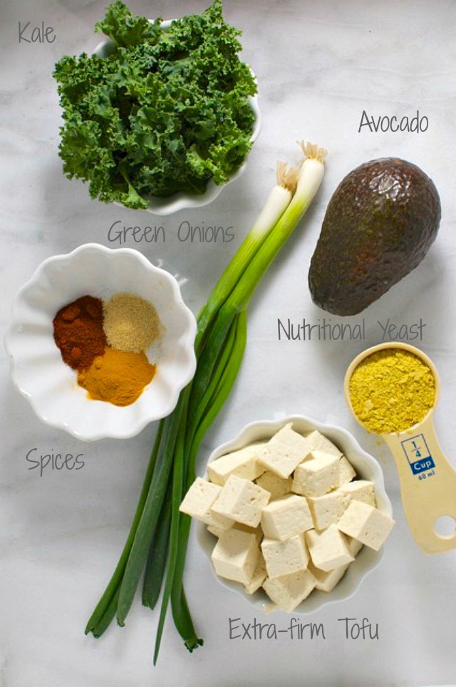 Looking down on ingredients for this tofu scramble, including tofu cubes, green onion, and more.