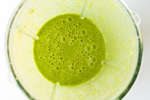Looking into a blender with Green Smoothie mixture at bottom