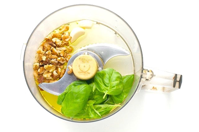 Ingredients for pesto in a food processor.