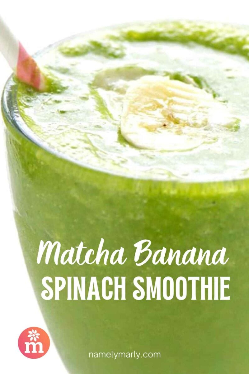 A glass is full of green smoothie. It has a pink straw and a banana slice on top. The text reads, Matcha Banana Spinach Smoothie.