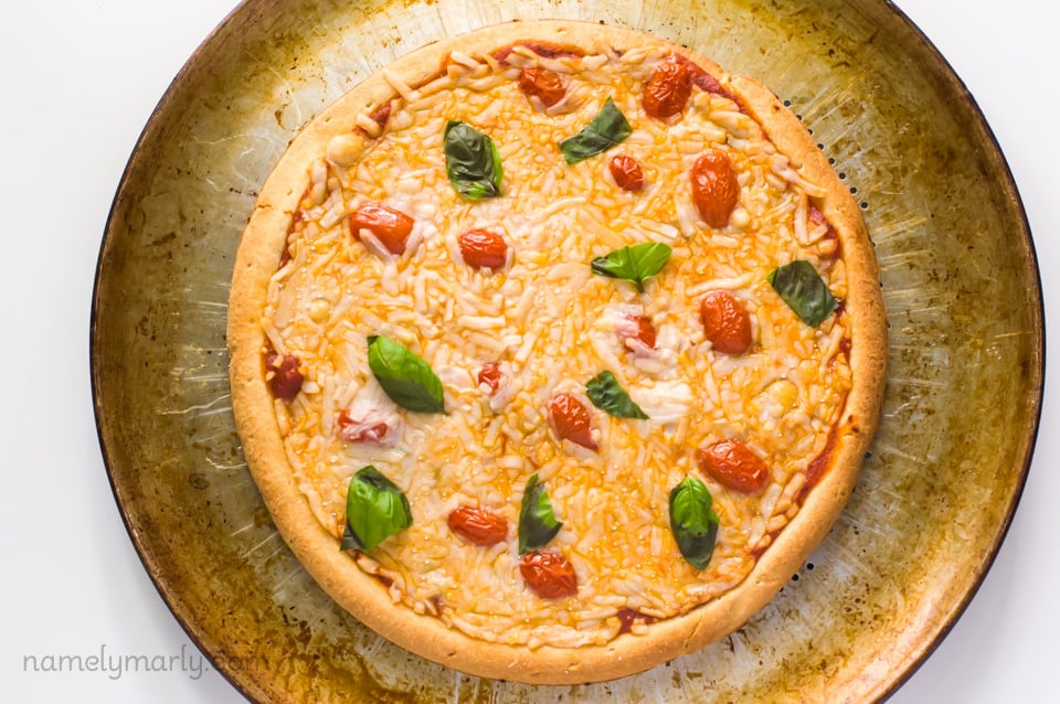 Looking down on a recently baked pizza on a pizza pan.