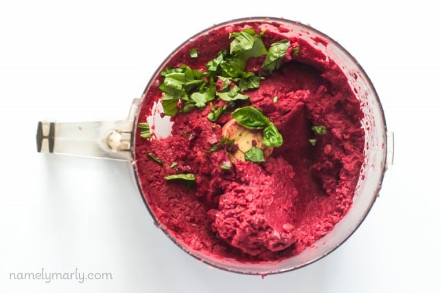 Looking down on beet hummus in a food processor bowl.