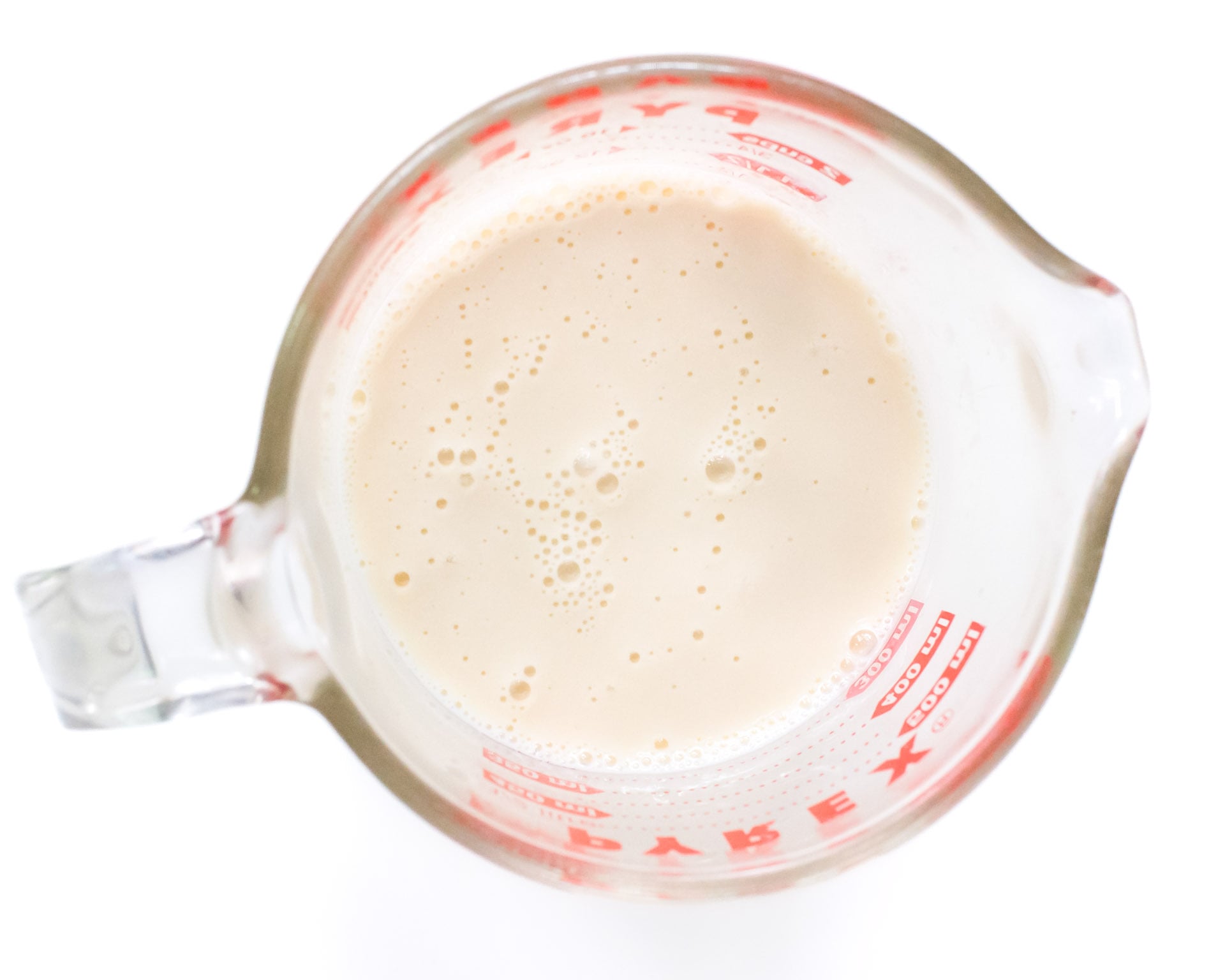 plant-based milk in a measuring cup