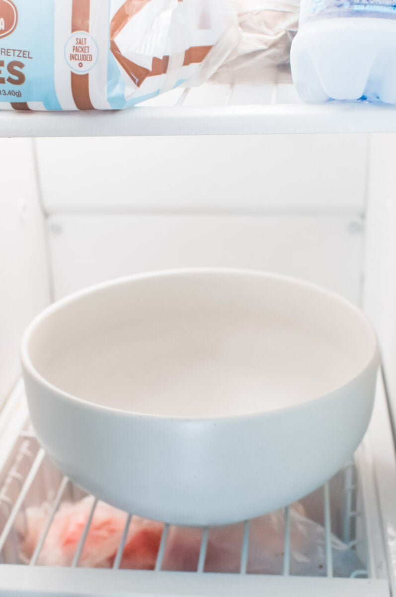 An empty large bowl is in the freezer.