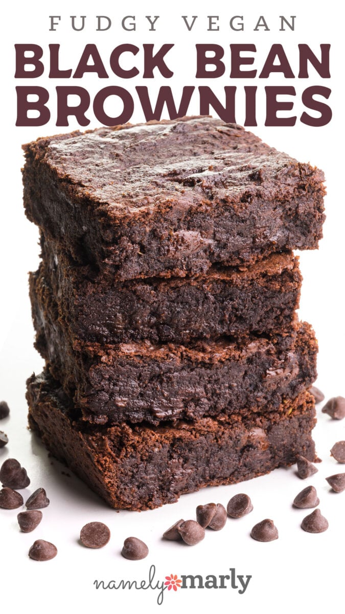Stack of fudgy vegan black bean brownies with chocolate chips on a white surface.