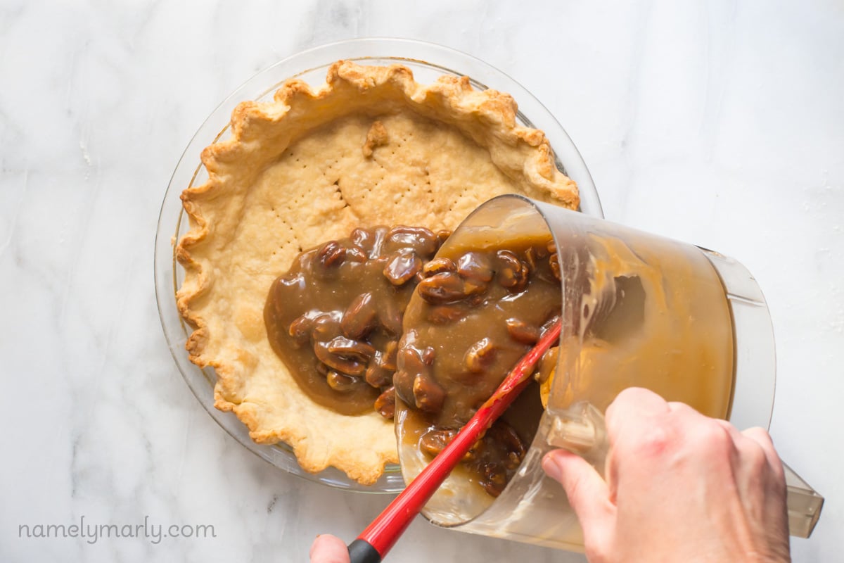 Pouring the custard into the prepared pie crust for this amazing Vegan Pecan Pie!