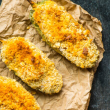 A closeup of vegan baked jalapeño poppers on a paper.