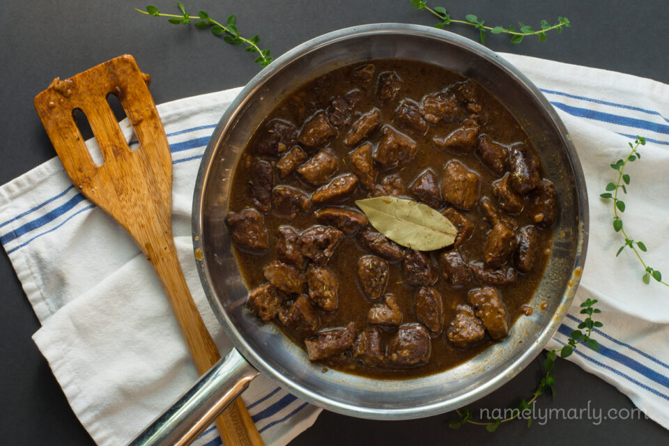 An overhead view of a saucepan containing vegan beefless tips in sauce.