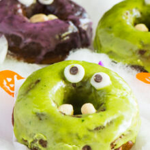 Purple and green donuts with googly eyes for Halloween.