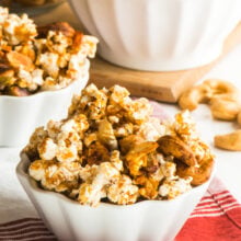 Vegan Cinnamon Popcorn Trail Mix in a small serving bowl with a larger bowl full of it behind it.
