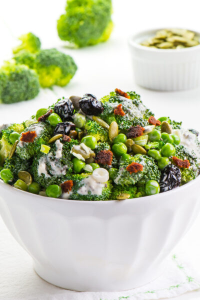 This Vegan Broccoli Salad is made with lightly steamed broccoli, pumpkin seeds, cranberry raisins, and vegan bacon pieces. You're going to love the lightly sweet dressing as well. It's a perfect salad for your next family gathering or party!