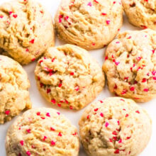 This photo looks down on a countertop where several valentines cookies are placed next too each other.