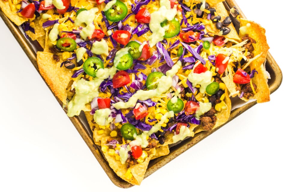 A baking sheet is loaded with baked vegan nachos.