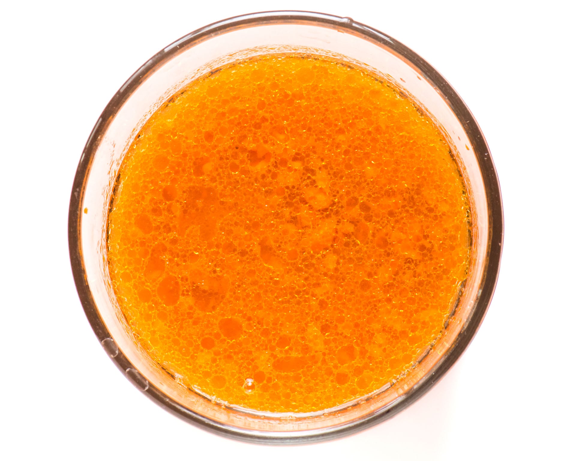 The wet ingredients for this healthy carrot cake recipe are in a glass mixing bowl.