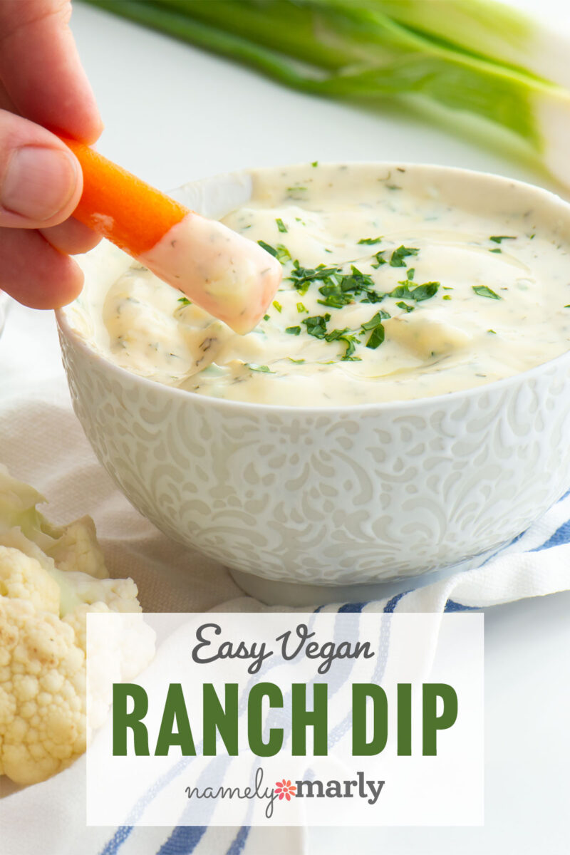 A hand dipping a carrot into a bowl of ranch dip with text that reads, Easy Vegan Ranch Dip