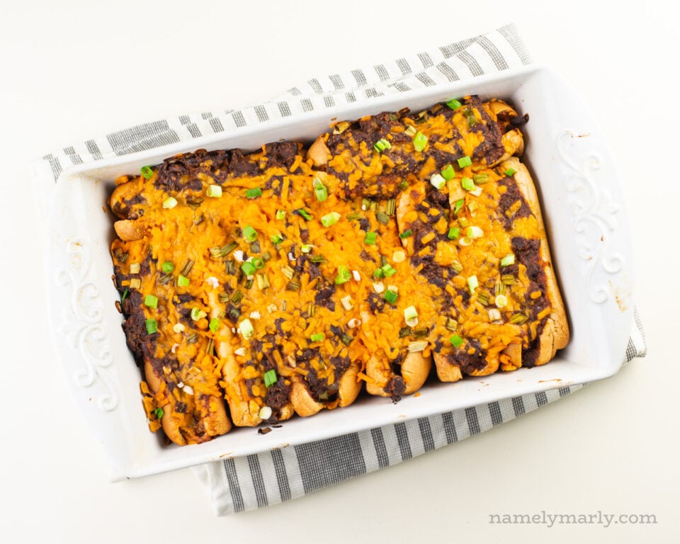 Vegan baked hot dogs in the casserole dish fresh from the oven.