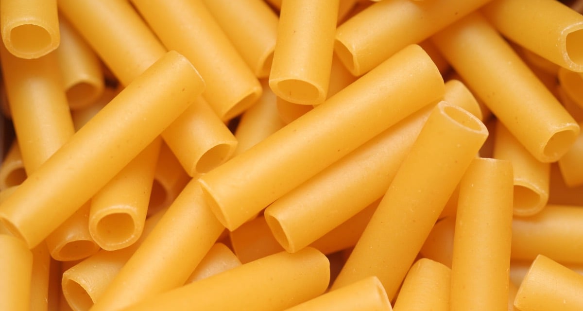 Looking down on a mound of uncooked ziti noodles.