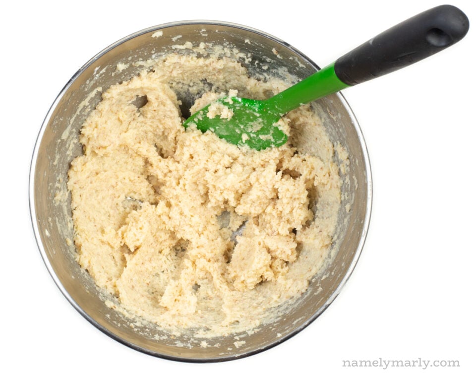 Batter in a mixing bowl with a green spatula.