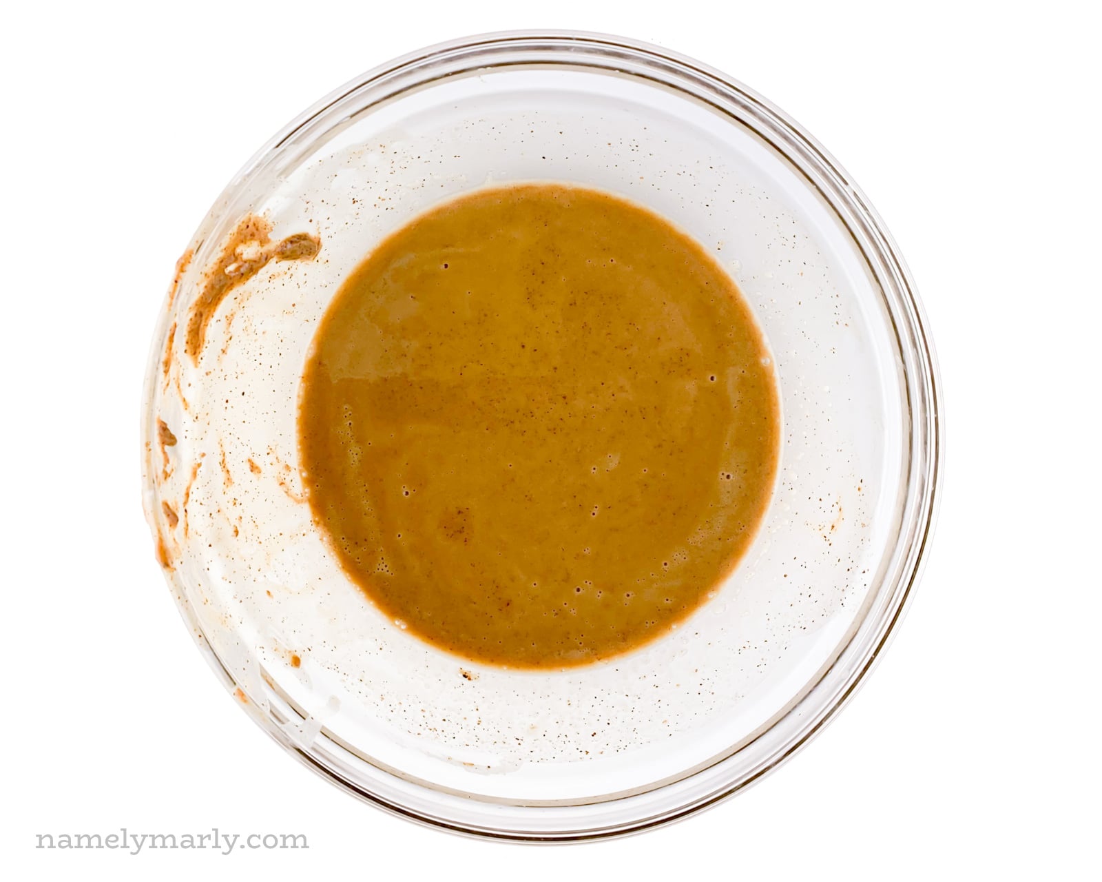 Almond butter with melted vegan butter in a glass bowl.