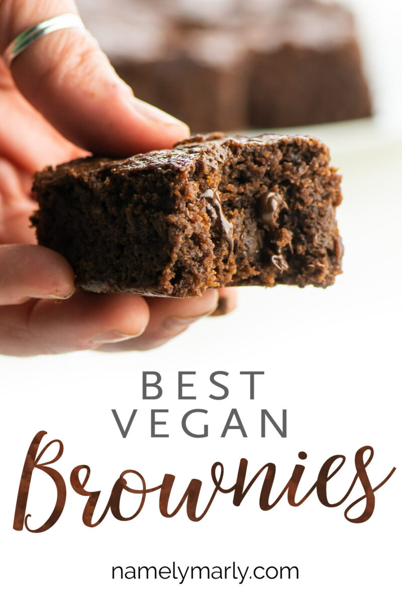 A hand holding a piece of a chocolate brownie with the text below Best Vegan Brownies