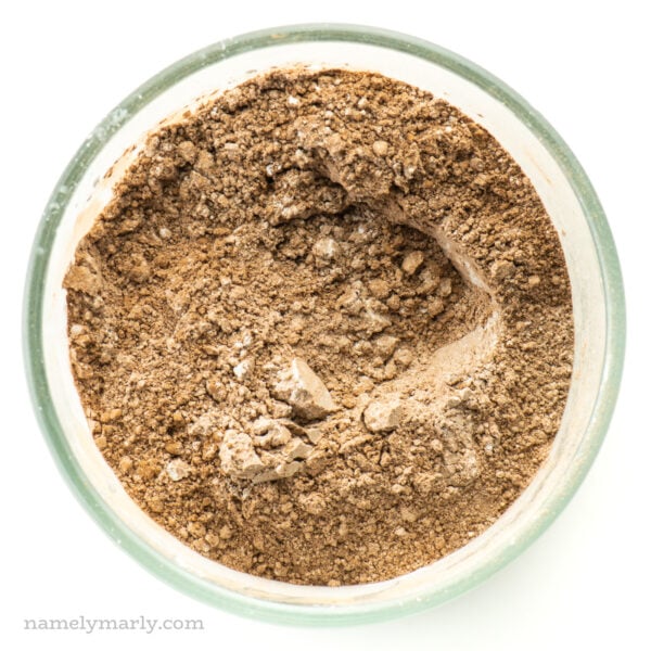 Looking down on a mixing bowl with flour, cocoa powder, and more.