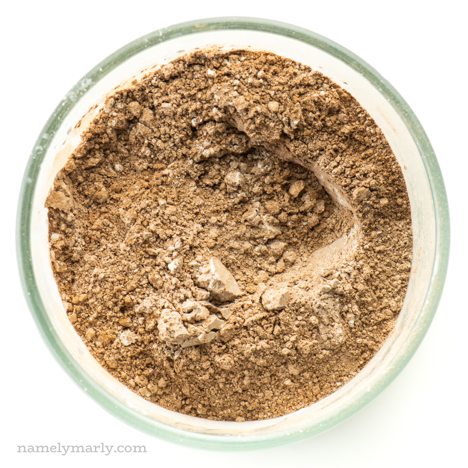 Looking down on a mixing bowl with flour, cocoa powder, and more.