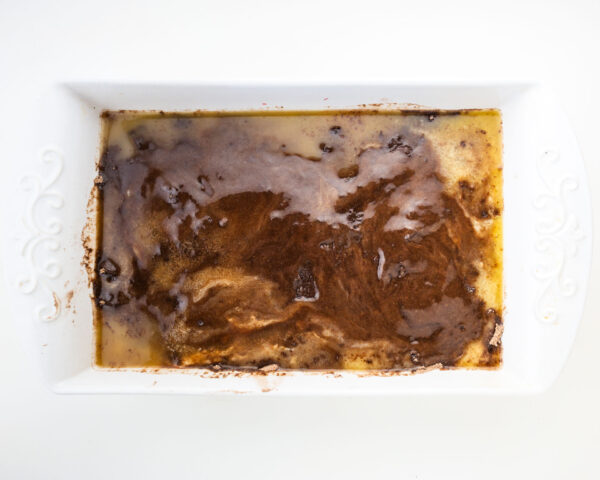 Looking down on cake mix that's been topped with butter.
