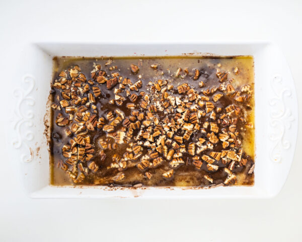 Chopped pecans on top of an unbaked cake.