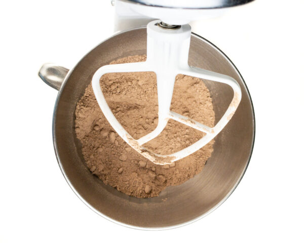 Flour and cocoa powder have been mixed in a mixing bowl in a stand mixer.