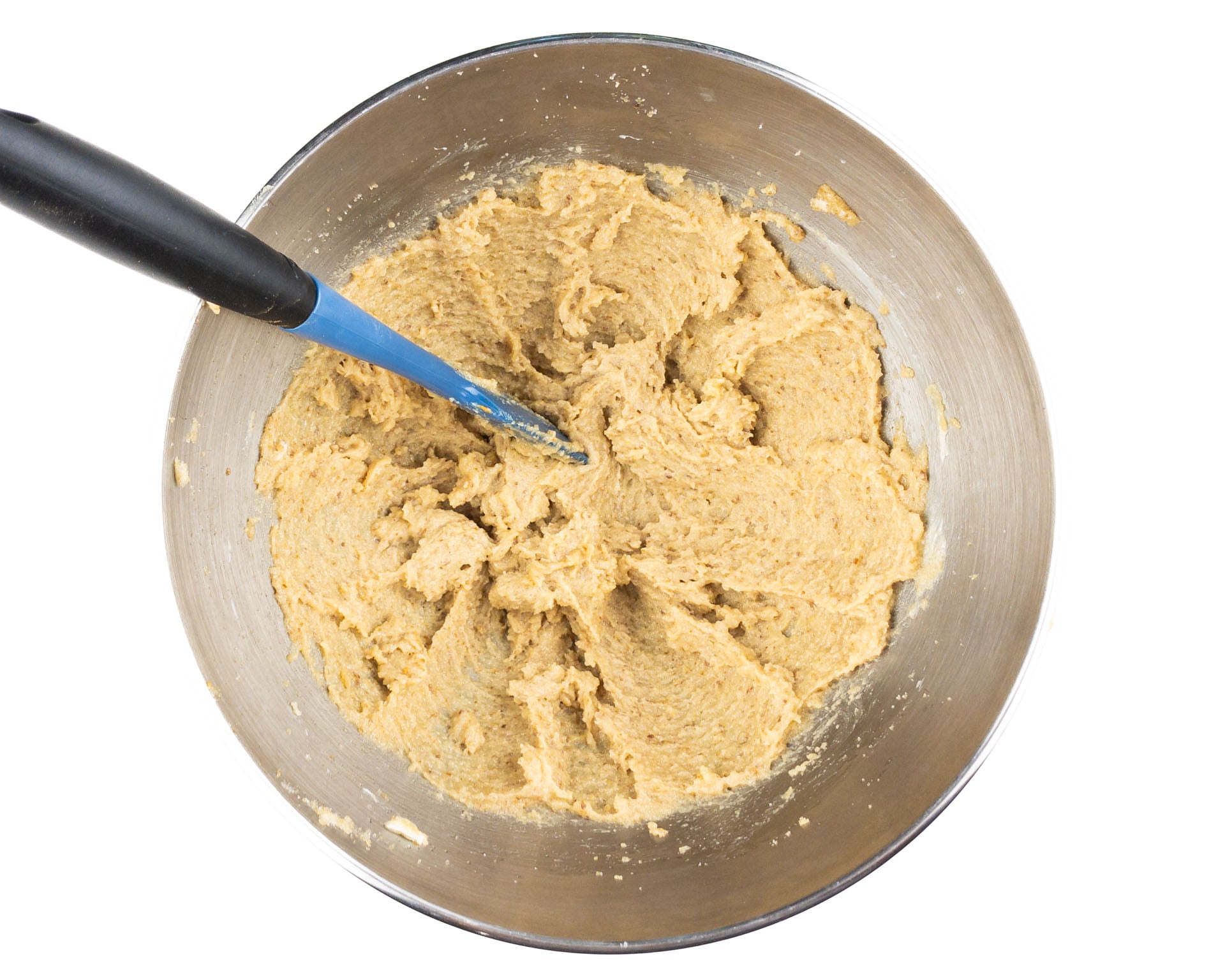 Butter and sugar have been mixed together in the bottom of a mixing bowl.