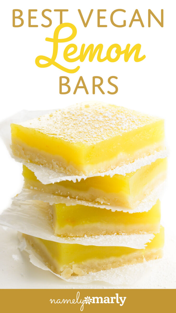 Stack of three vegan lemon bars dusted with powdered sugar on parchment paper.