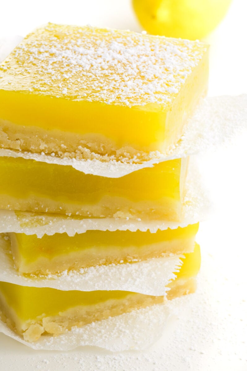 A stack of several dessert bars on a white counter.