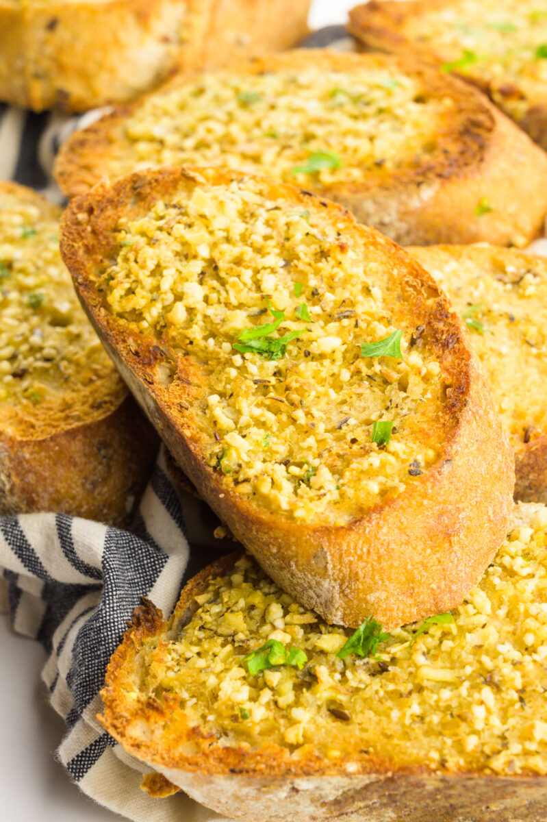 Looking down on several slices of toasted vegan garlic bread.