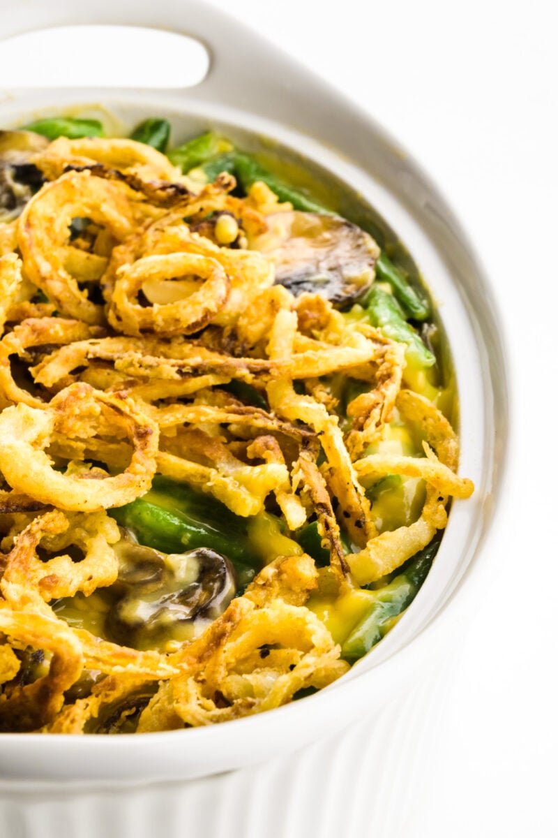 A casserole shows fried onions in a casserole dish with green beans.