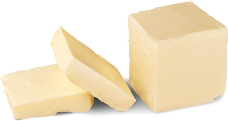 A stick of vegan butter has two slices cut out.