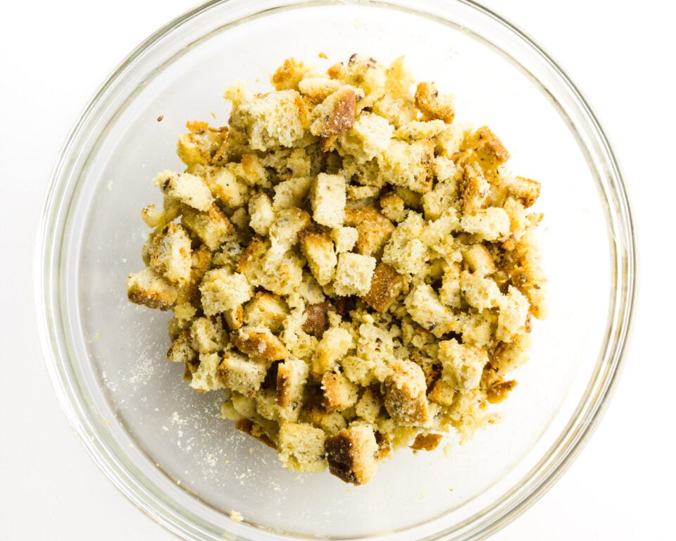 Bread crumbs are in the bottom of a glass bowl.