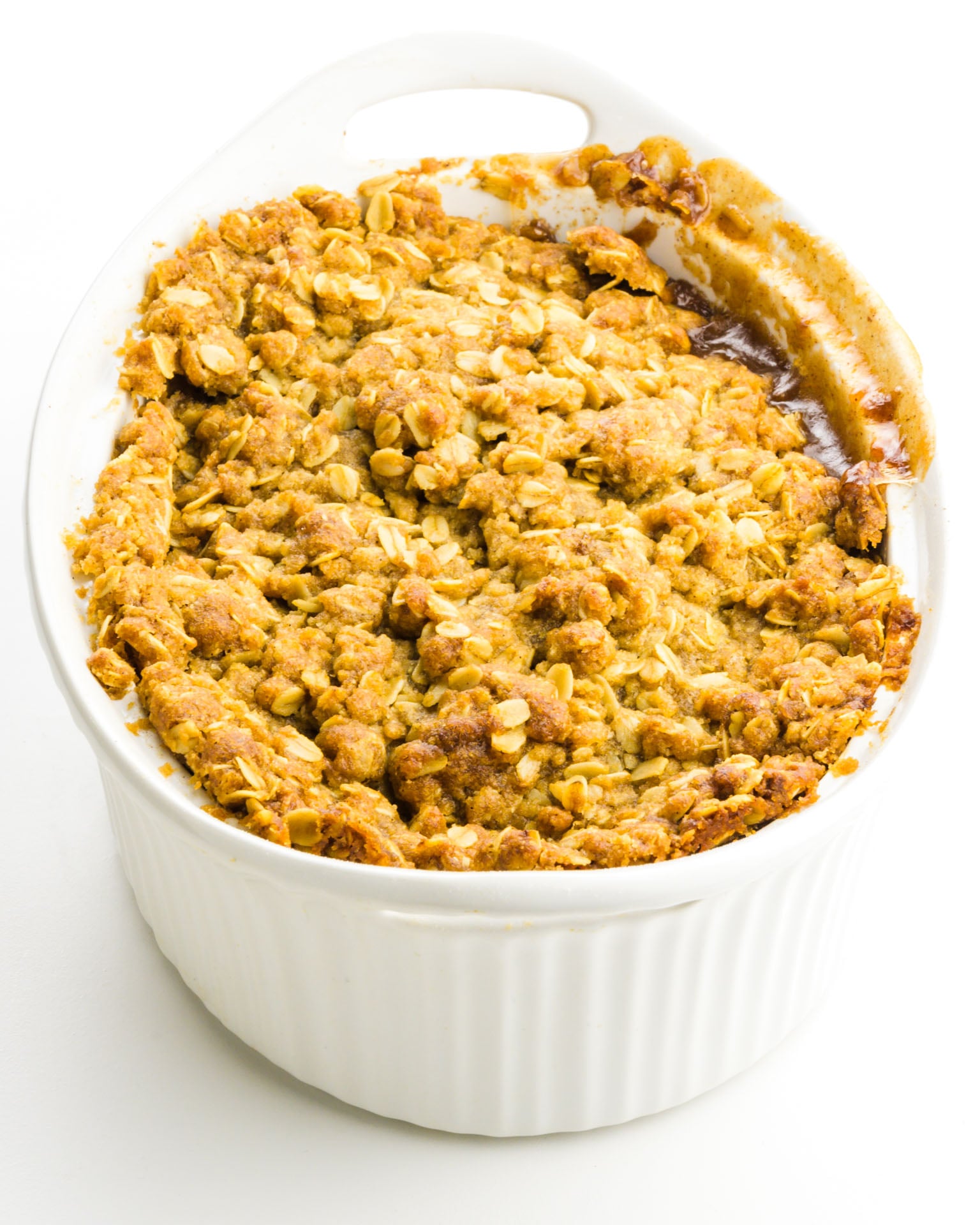 A casserole dish is full of apple crisp.