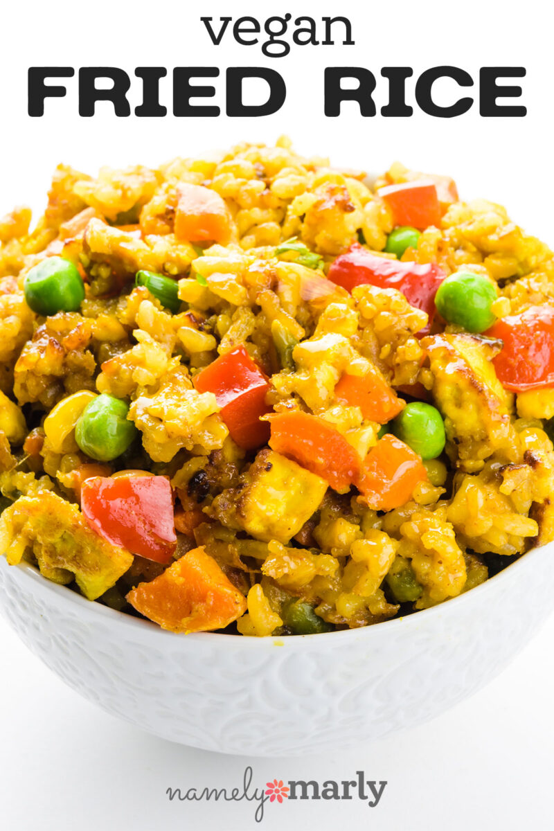 Vegan fried rice with colorful vegetables in a white bowl, topped with text "vegan FRIED RICE."