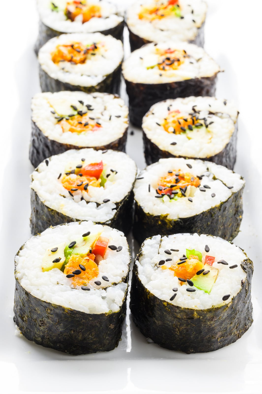 A platter holds two rolls of sushi rolls.