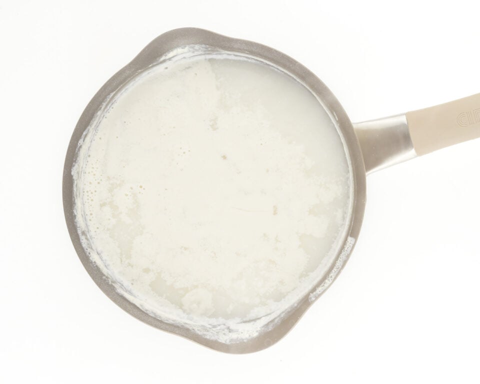 Plant-based milk is being simmered in s saucepan.