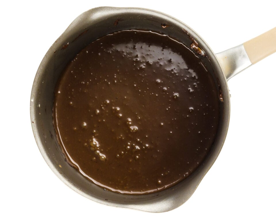 A chocolate sauce for making ice cream is in a saucepan.