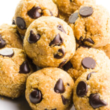 A plate holds several cookie dough bites, all with lots of chocolate chips!