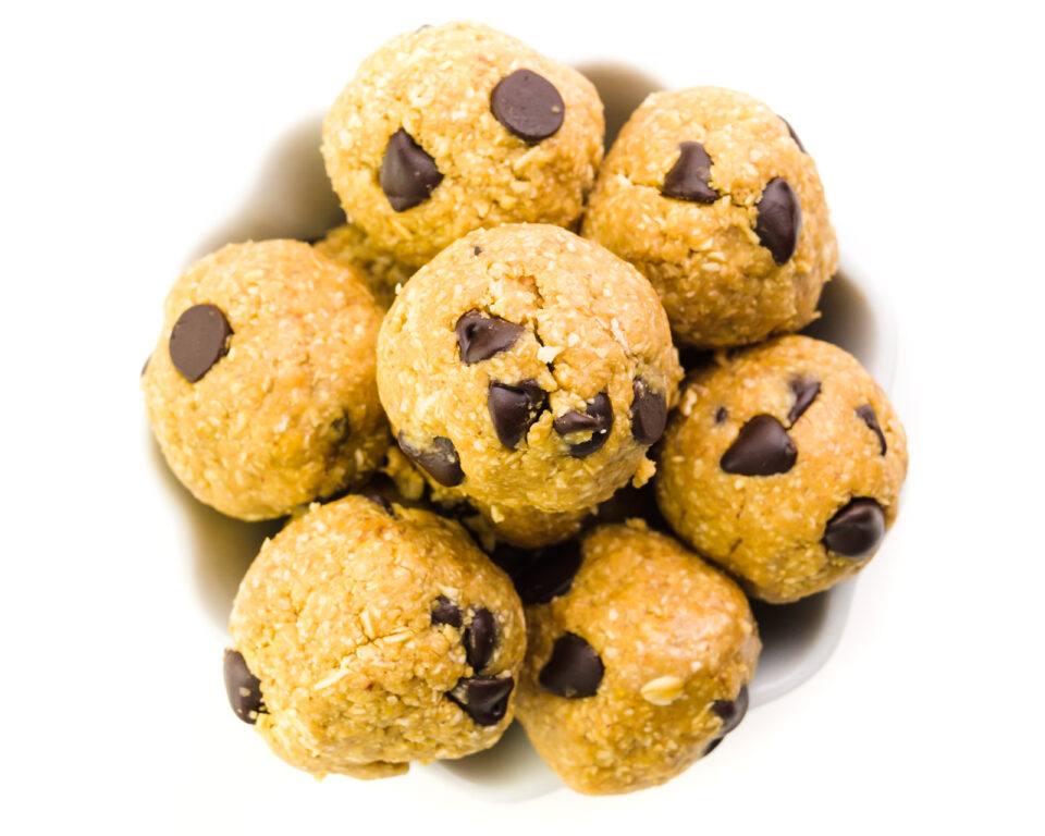 Looking down on a bowl full of chocolate chip cookie dough balls.
