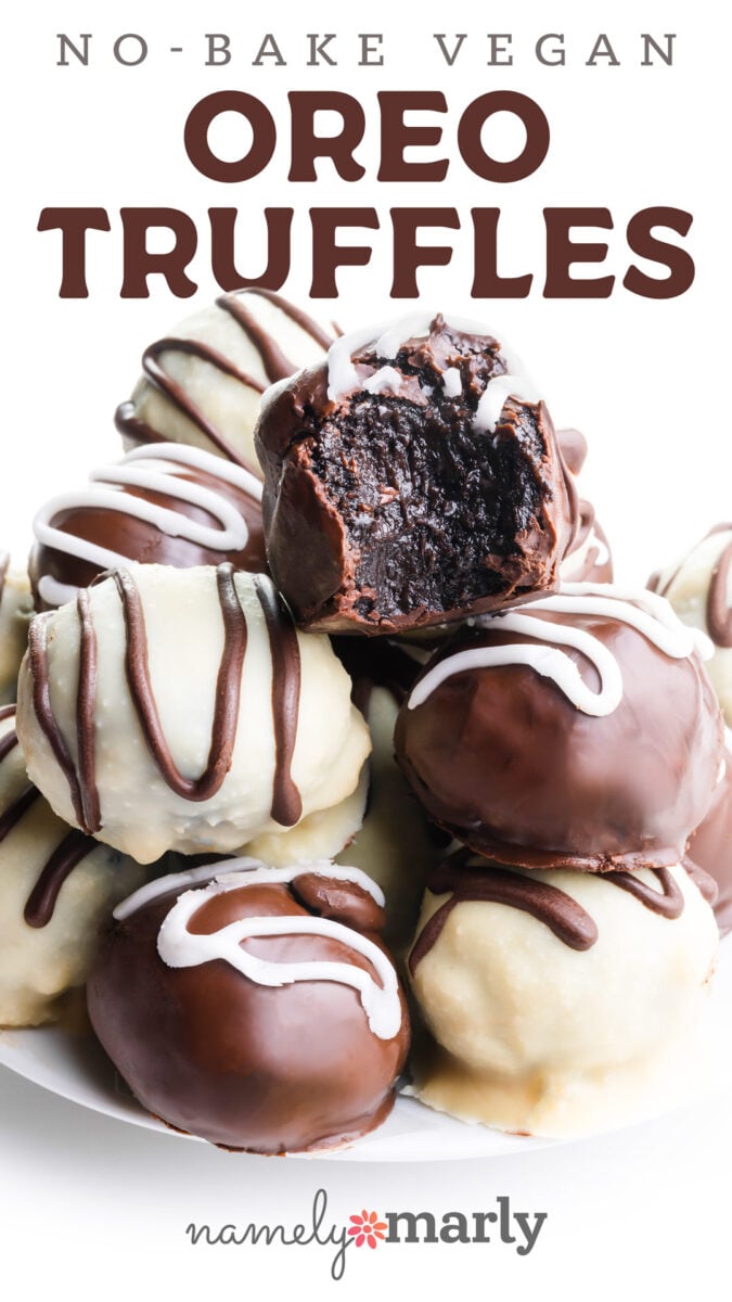 Vegan no-bake Oreo truffles coated in chocolate and white icing, piled on a white plate.